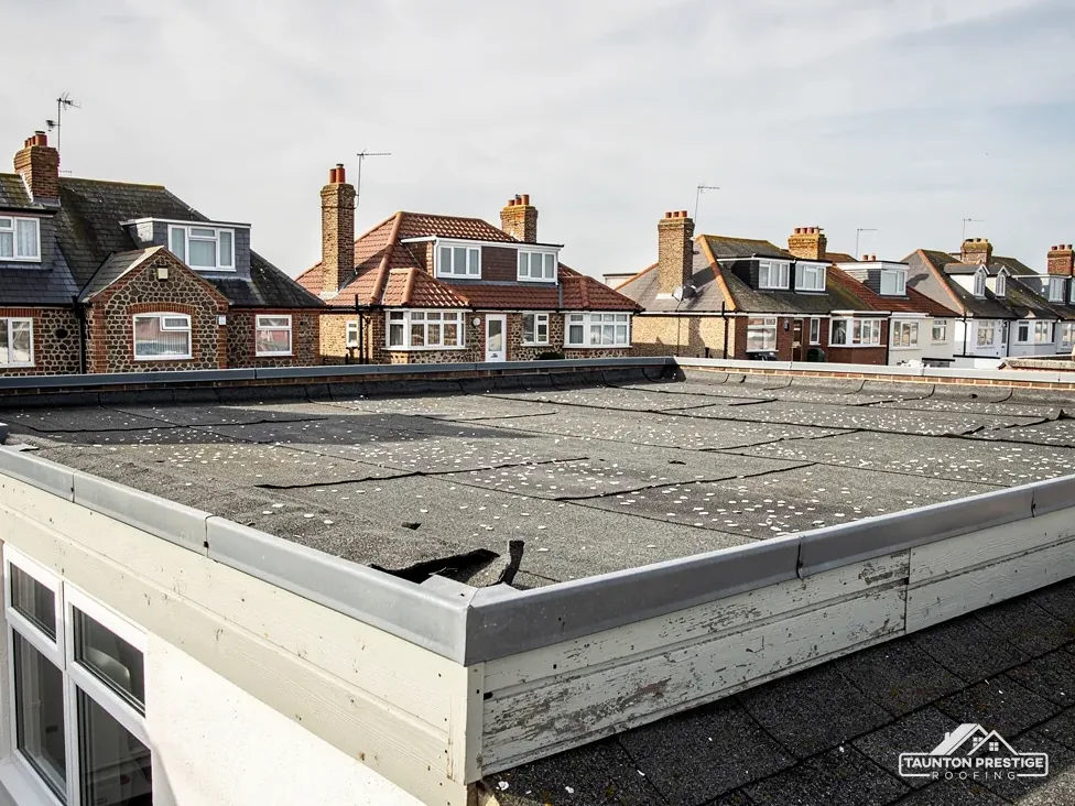 Blistered and cracked felt flat roof on a rear extension