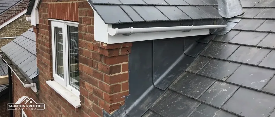 Lead flashing around a brick dormer on a slate roof