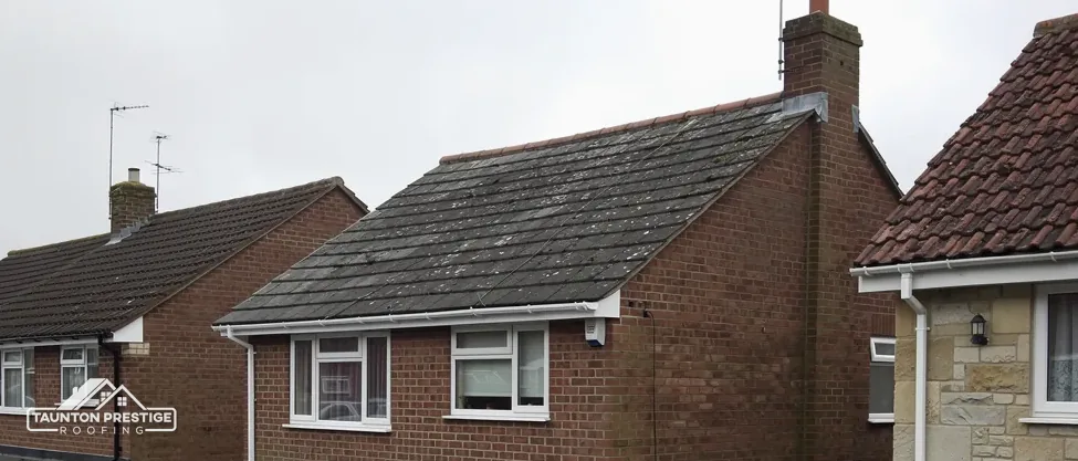 Flat-roofed garages and extensions behind brick semi-detached houses